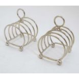 A pair of small silver plated 4 slice toast racks marked Harrods and numbered 875 2 1/4" long