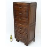 Art Deco : A French oak Semainier containing seven short solid oak draws with original brass