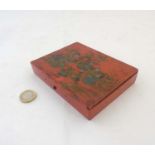 A Japanese lacquered persimmon red seal box depicting a female figure and children.