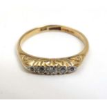 An 18ct gold ring set with 5 diamonds in a linear setting CONDITION: Please Note -