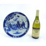 A Chinese blue and white charger/plate depicting imperial figures in an outdoor landscape,