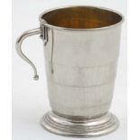 A silver plate expandable / travelling cup with gilded interior and loop handle.