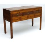 A mid 20thC Chinese three draw panelled Low Dresser standing on squared legs.