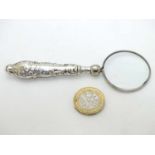 A silver handled magnifying glass 4 1/2" long CONDITION: Please Note - we do not