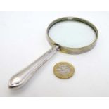 A magnifying glass with silver handle 5 1/2" long CONDITION: Please Note - we do