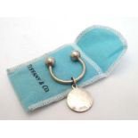 A silver keyring marked 'Sterling Tiffany & Co' CONDITION: Please Note - we do not