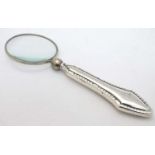 A magnifying glass with silver handle 4 1/2" long CONDITION: Please Note - we do