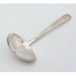 A silver sifter spoon with hammered and pierced decoration. Indistinctly marked.