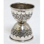 An embossed silver double measure hallmarked Birmingham 1923 maker A J Bailey 2 3/8" high overall