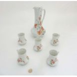 A Limoges France Giraud Belle Epoque jug together with five cups each with poppy decoration on