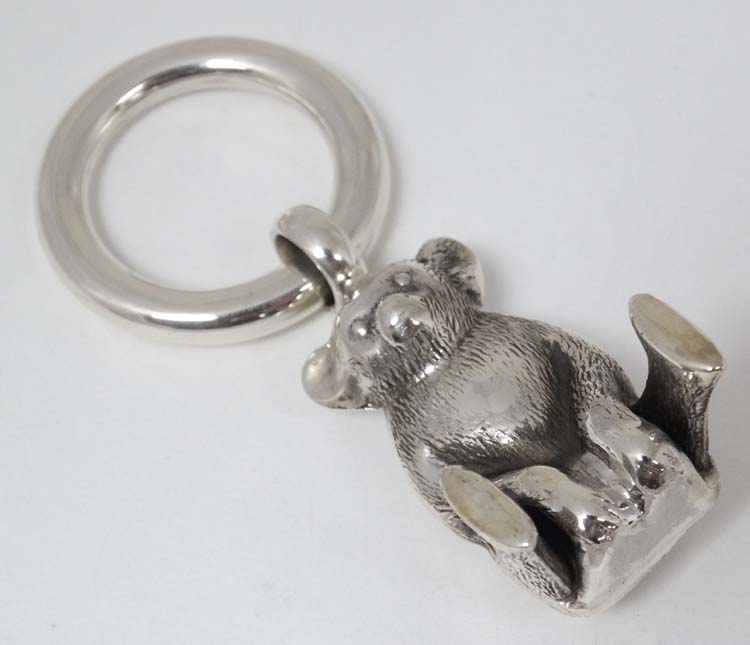 A 925 silver rattle / charm formed as a Teddy bear.