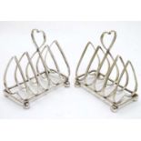 A pair of silver 4-slice toast rack with heart shaped bars and handles.