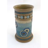 An 1884 Royal Doulton Lambeth silicon ware pot with banded decoration in cream, blues and browns,