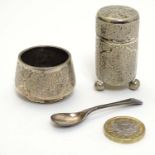 A white metal salt and pepperette marked under with eastern script, together with spoon.