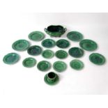A set of Majolica glazed kitchen items with green grape vine decoration, to include 4 dinner plates,