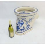 A Victorian blue and white transfer printed '' Waterfall Closet '' toilet decorated with flora,
