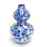 A Chinese Blue and White double gourd vase depicting bats (Fu) amidst gourd fruit plant,