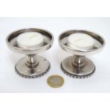 A pair of silver plate candle / tea light holders.