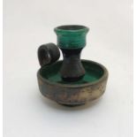 Scandinavian Pottery: A Retro Swedish Szilasi chamberstick decorated in a green and black glaze,