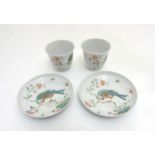 A pair of Chinese Famille Rose tea cups and saucers,