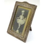 A silver frame with bow harebell and swag decoration. Hallmarked Birmingham 1907 maker Sydney & Co.