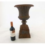 Salvage, Garden and Architectural: a 20thC Campana shaped cast iron pedestal urn on squared socle,