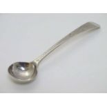 A Geo III old English pattern salt spoon of ladle form with bright cut decoration to handle.