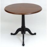 A 20thC mahogany Occasional Table with an oval top allowing for height adjustment,