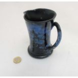 A Welsh black and blue mottled jug by Ewenny, makers mark to base,