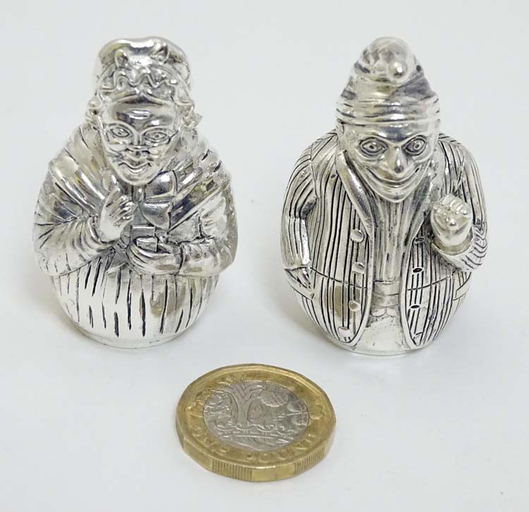 A pair of white metal novelty pepperettes formed as Punch and Judy figures.