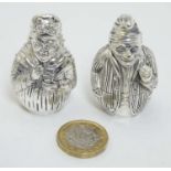 A pair of white metal novelty pepperettes formed as Punch and Judy figures.