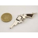 A pendant formed as a hand gun / revolver. 21stC .