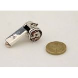 Dog interest : A .925 silver whistle having two applied enamel dogs head cabochon. 21stC.