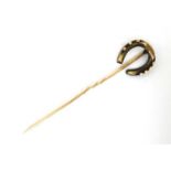 Horse Riding Interest: A gilt metal stick pin surmounted by a horseshoe CONDITION: