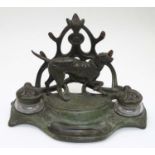 An early - mid 20thC spelter Standish with dog and stylised Art Nouveau foliate decoration with