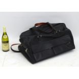 A black leather weekend/ travel bag with strap with embossed Rolls Royce mark,
