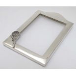 A silver photograph frame surround with tennis racket motif. Marked Sterling .