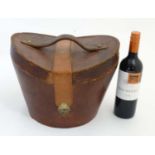 A mid 20thC '' Brooks Brothers '' brown leather saddle shaped hat box with red silk lining ,