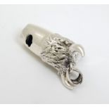 A novelty silver whistle with bulls head decoration.