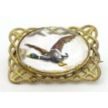 A gilt metal brooch set with Essex Crystal cabochon to centre depicting a Mallard duck in flight 1"