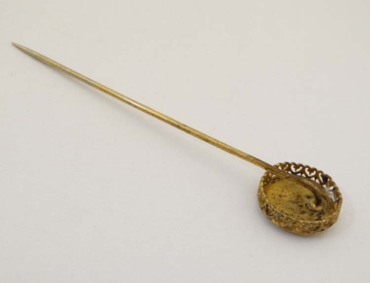 A gilt metal stick pin surmounted by a circular image of a squirrel. - Image 2 of 4