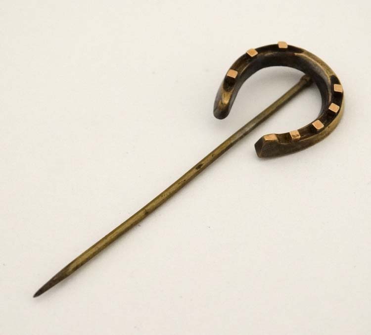 A gilt metal stick pin surmounted by a horseshoe 2 3/4" long CONDITION: Please