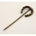 A gilt metal stick pin surmounted by a horseshoe 2 3/4" long CONDITION: Please