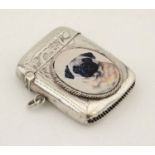 A hallmarked silver vesta case with later applied 21stC ceramic cabochon depicting image of a pug