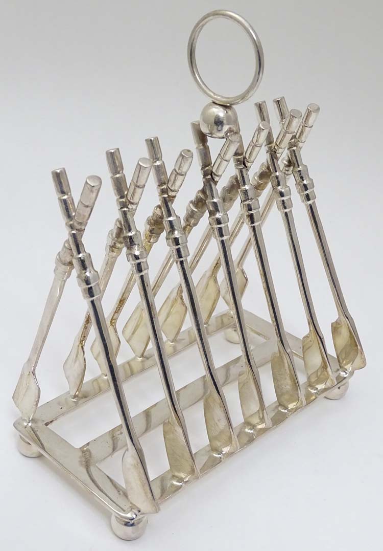 Rowing: A novelty 6-slice silver plated toast rack, the bars formed as oars.