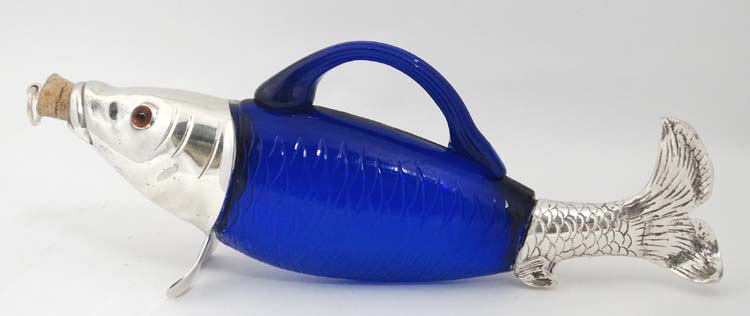 A novelty claret jug / decanter formed as a fish with blue glass body,