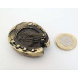 A novelty brass vesta case of horseshoe form with horse head to centre.