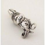 A novelty silver whistle with elephant head decoration.