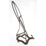 Equestrian: An early 20thC black wall mounted metal standard size saddle rack.