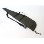 Shooting : A 'scoped rifle slip , having green synthetic finish ,